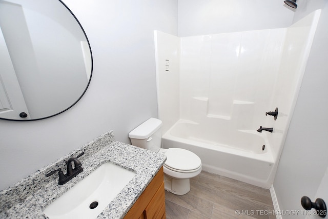 full bathroom featuring toilet, shower / bath combination, hardwood / wood-style flooring, and vanity