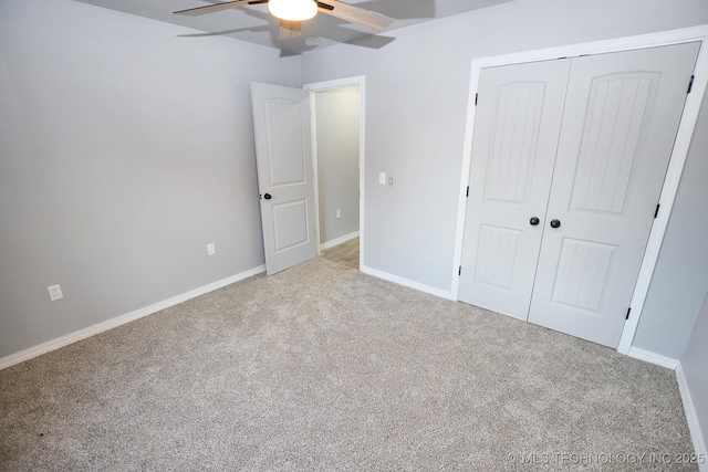 unfurnished bedroom with ceiling fan, light colored carpet, and a closet