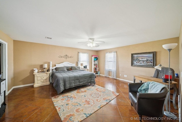 bedroom with ceiling fan and dark tile patterned flooring