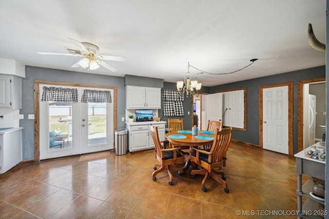 dining room with ceiling fan with notable chandelier, light tile patterned floors, and french doors