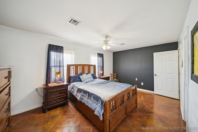 tiled bedroom featuring ceiling fan