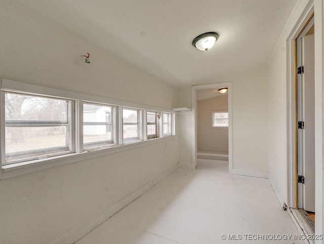 hallway featuring vaulted ceiling