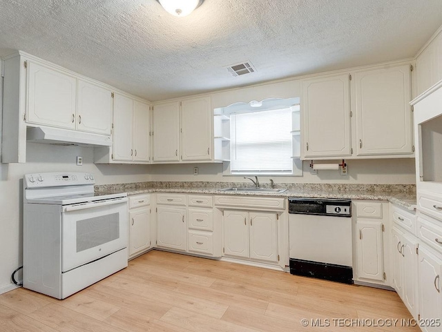 kitchen with sink, white appliances, and white cabinetry