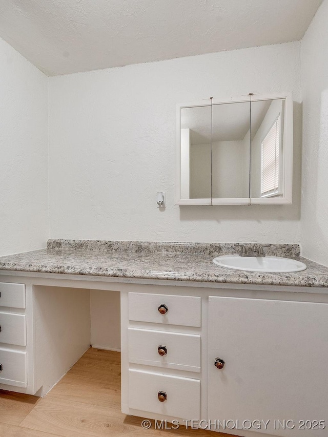 bathroom with vanity and hardwood / wood-style flooring