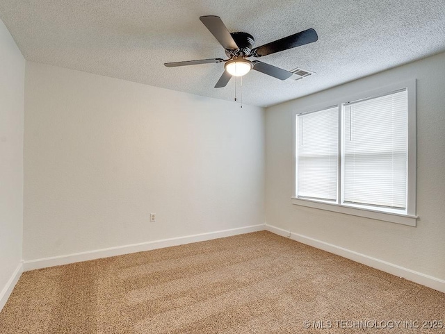 spare room with a textured ceiling, ceiling fan, and carpet