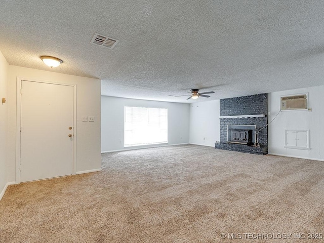 unfurnished living room featuring ceiling fan, a wall mounted AC, and carpet flooring