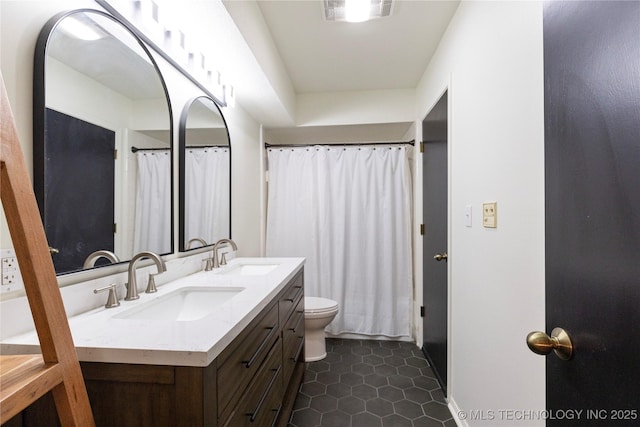 bathroom with tile patterned floors, toilet, and vanity