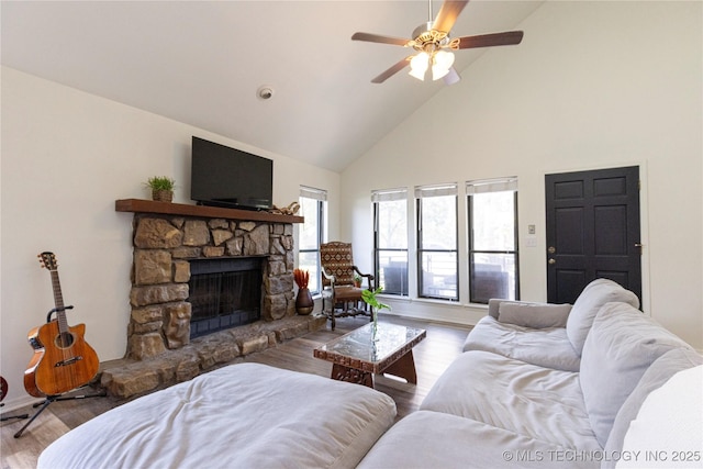 living room with high vaulted ceiling, light wood-type flooring, ceiling fan, and a fireplace