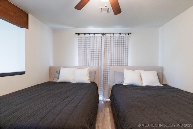 unfurnished bedroom with ceiling fan and wood-type flooring