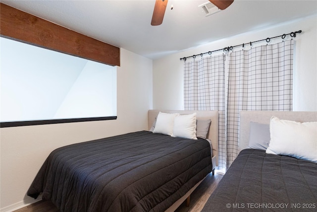 bedroom with ceiling fan and dark hardwood / wood-style flooring