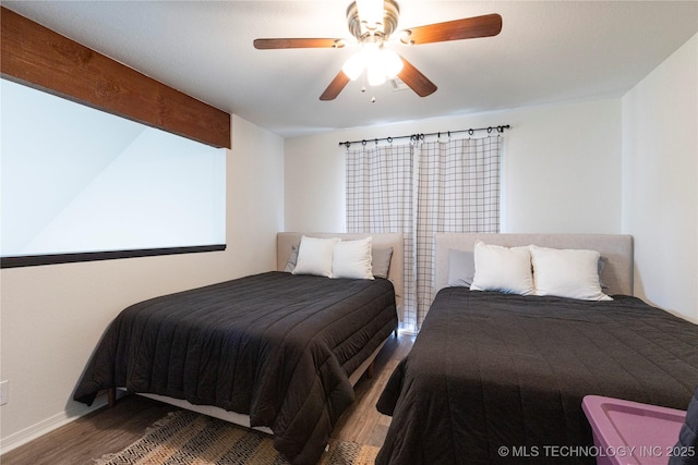 bedroom featuring ceiling fan, beam ceiling, and hardwood / wood-style floors