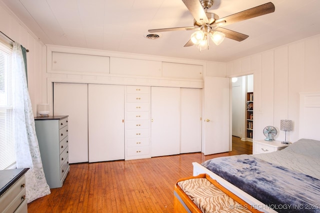 bedroom with ceiling fan, a closet, and hardwood / wood-style floors