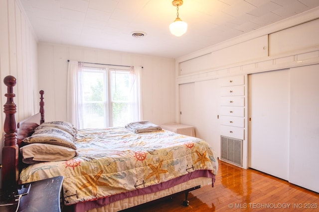 bedroom with hardwood / wood-style floors and crown molding