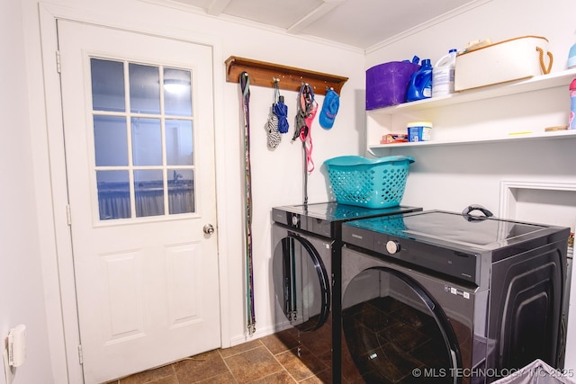 clothes washing area with washing machine and dryer