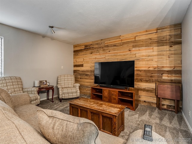 carpeted living room featuring wood walls