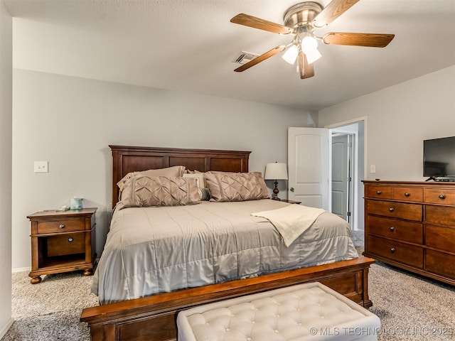 bedroom with ceiling fan and light carpet