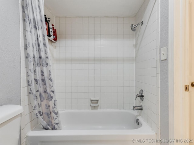 bathroom with toilet and shower / bath combination with curtain