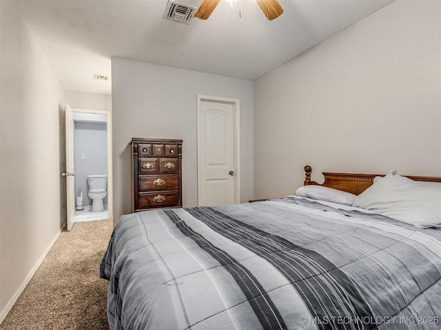 bedroom with ceiling fan, ensuite bathroom, and carpet floors