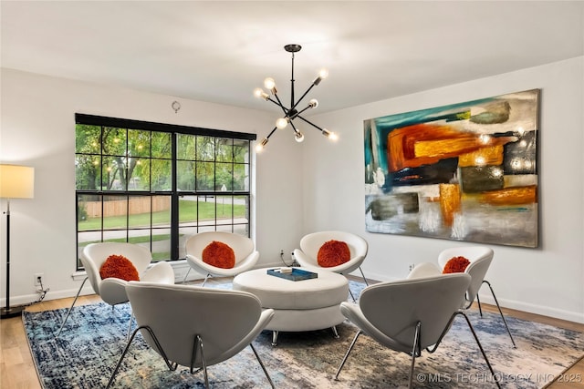 dining room with a chandelier, wood finished floors, and baseboards