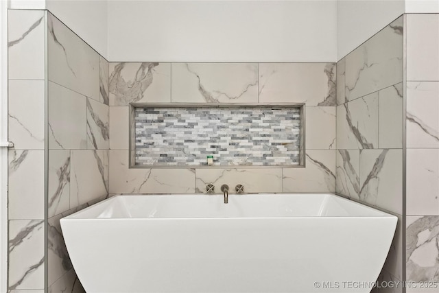 full bathroom with a soaking tub and tile walls