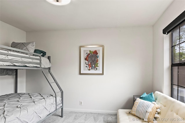 carpeted bedroom featuring baseboards