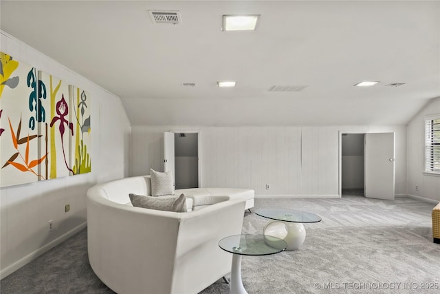 living area featuring vaulted ceiling, carpet, and visible vents