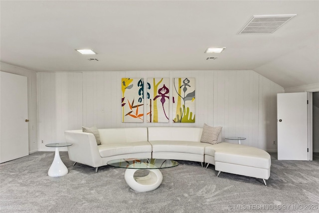 carpeted living room featuring visible vents and vaulted ceiling