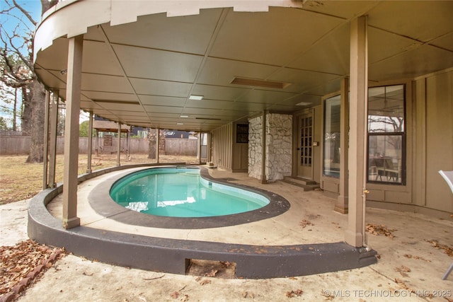 view of pool featuring entry steps, fence, and a patio