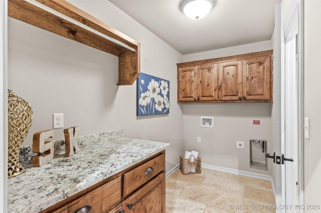 washroom with hookup for an electric dryer, baseboards, washer hookup, and cabinet space