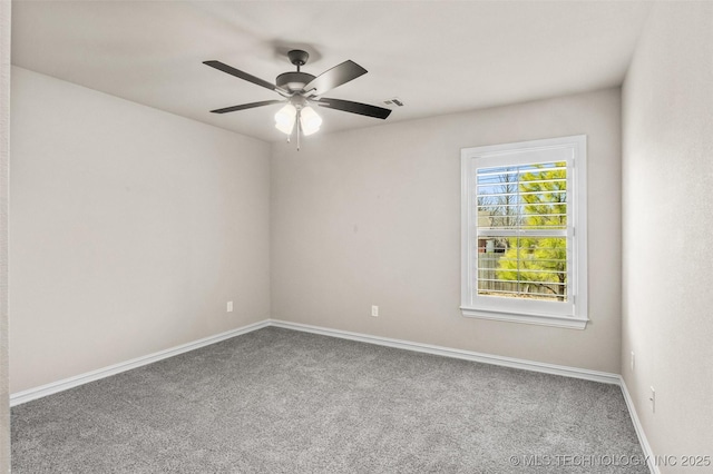 empty room with baseboards, a ceiling fan, and carpet