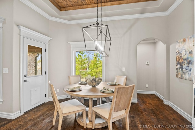 dining area featuring dark wood finished floors, arched walkways, a chandelier, wood ceiling, and a raised ceiling