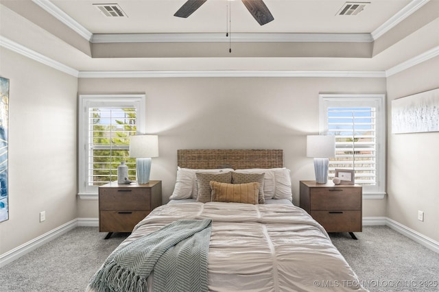 bedroom featuring visible vents, a tray ceiling, and carpet floors