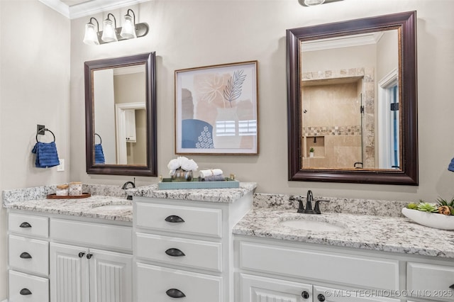 bathroom featuring a sink, ornamental molding, and two vanities