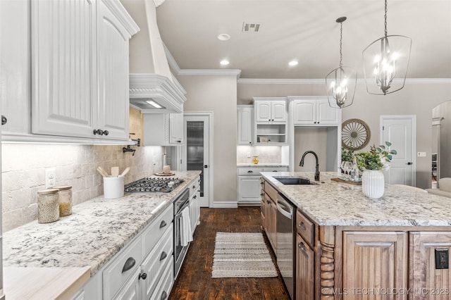kitchen featuring crown molding, appliances with stainless steel finishes, a sink, and visible vents
