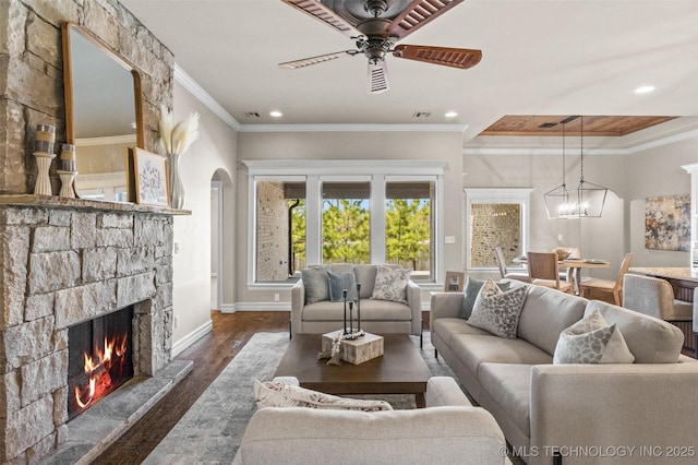 living area with baseboards, dark wood finished floors, a fireplace, recessed lighting, and ceiling fan with notable chandelier
