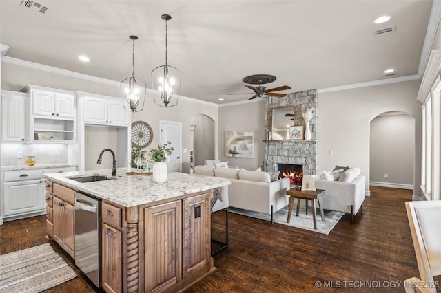 kitchen with recessed lighting, ceiling fan, arched walkways, dishwasher, and a sink
