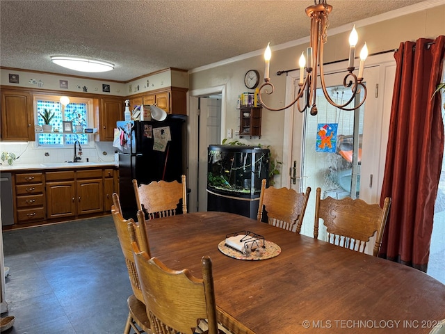 dining room featuring ornamental molding, a chandelier, sink, and a textured ceiling