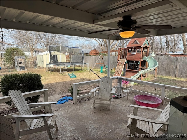 view of patio / terrace with a trampoline, a storage shed, and a playground