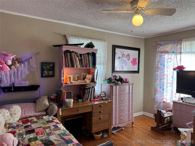 bedroom with a textured ceiling, ceiling fan, and hardwood / wood-style flooring