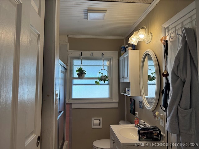 bathroom with vanity, crown molding, and toilet