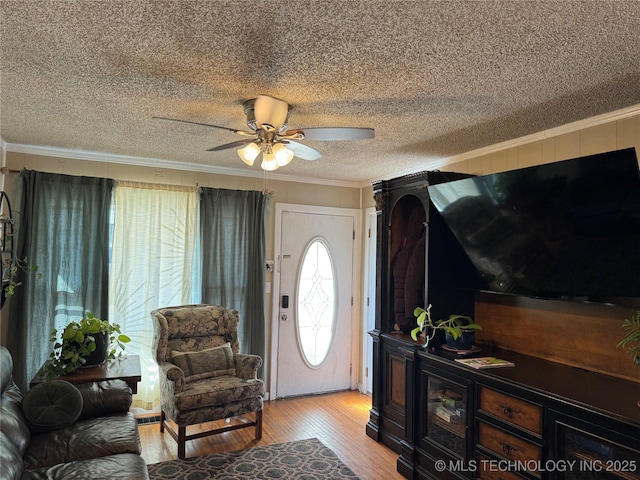 foyer with crown molding, light hardwood / wood-style floors, ceiling fan, and a textured ceiling