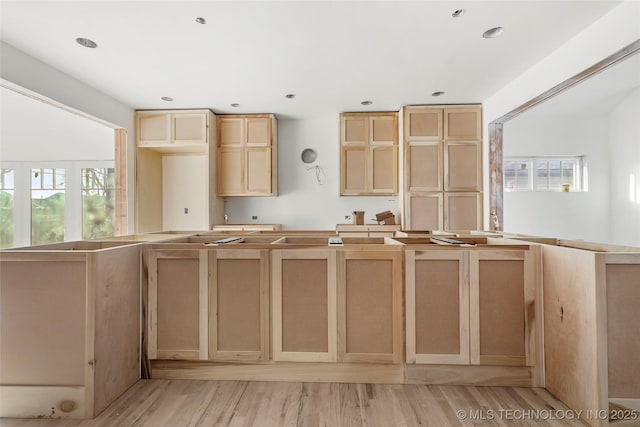 kitchen featuring light brown cabinetry and light hardwood / wood-style floors