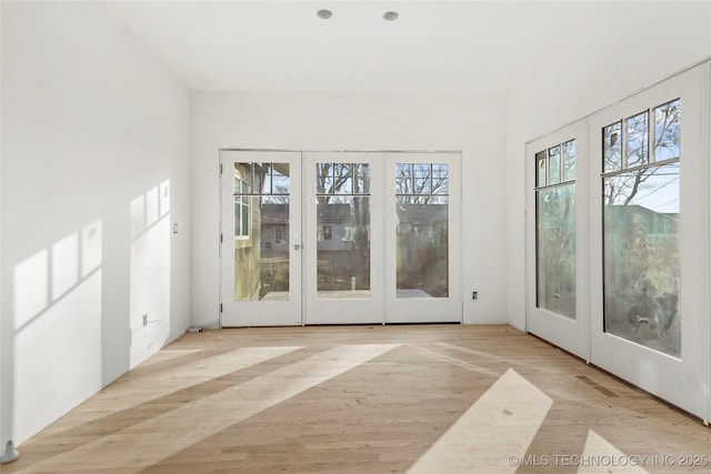 unfurnished sunroom featuring french doors