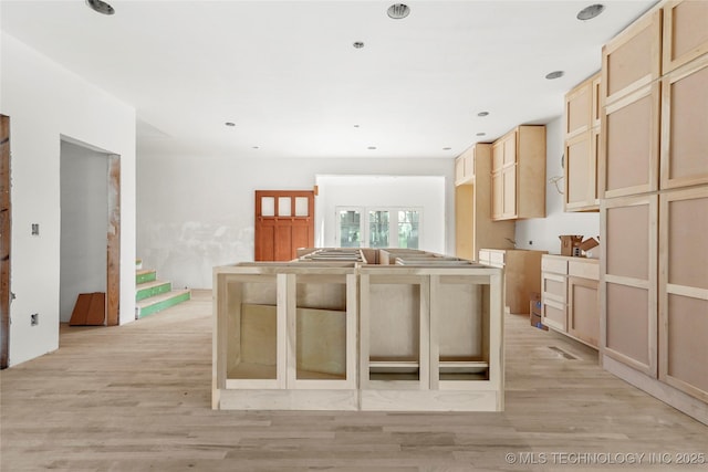 kitchen featuring light brown cabinetry, light hardwood / wood-style floors, and a kitchen island