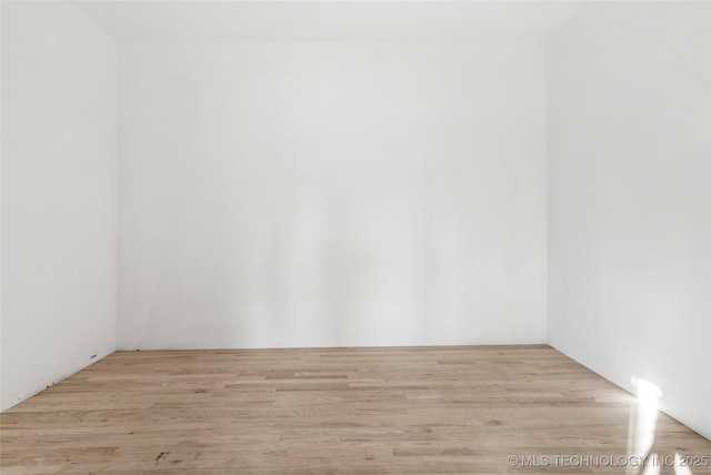 empty room with light hardwood / wood-style flooring