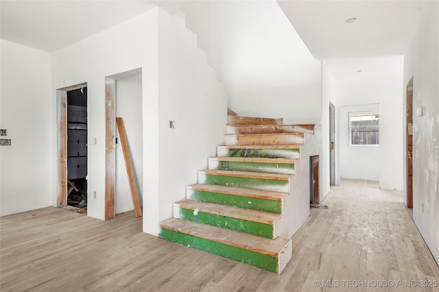 staircase with hardwood / wood-style flooring