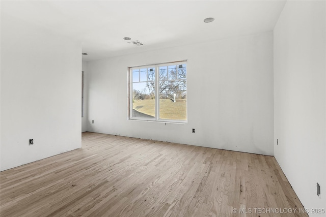 spare room featuring light wood-type flooring