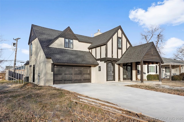 view of front of home featuring cooling unit and a garage