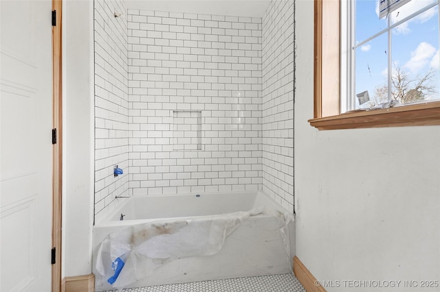 bathroom with a tub to relax in