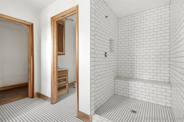 bathroom with a tile shower